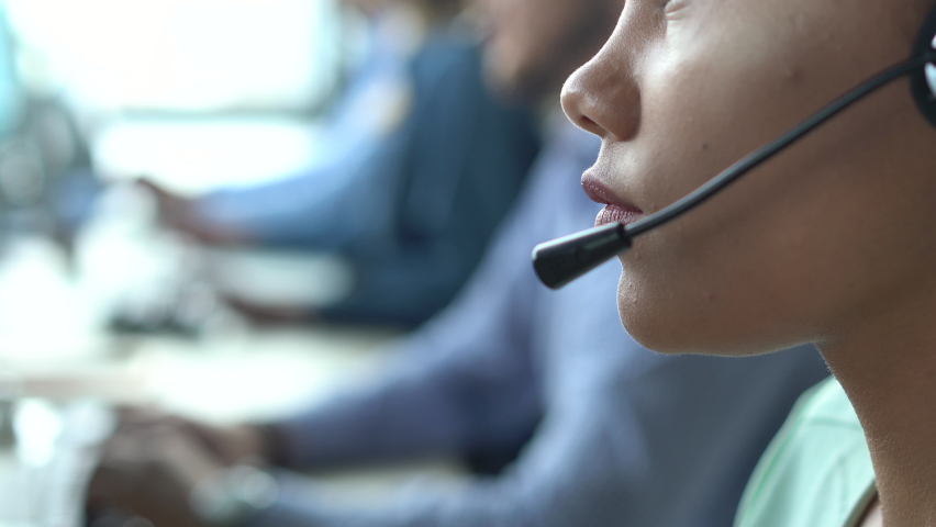 Mixed race African American woman with headset using computer, talking, working customer support service operator | Shutterstock HD Video #1075916954