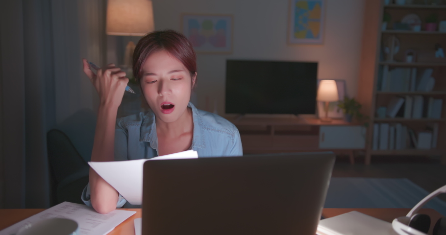 Work from home -Tired asian business woman sitting at desk headache overtime working late night in living room | Shutterstock HD Video #1075922225