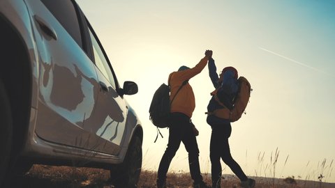 teamwork success. car a travelers with backpacks silhouette. victory teamwork business freedom concept. friendly team of hikers silhouette win. business success. happy family on a car with backpacks