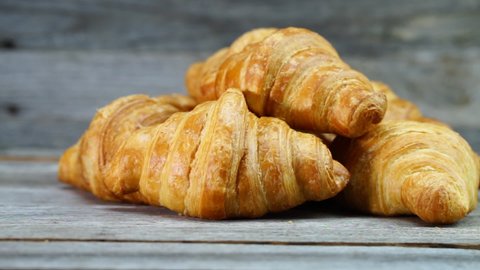 Close up of croissants isolated on wooden board. French breakfast concept