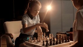 Beautiful cute schoolgirl playing chess with a classmate during the championship. Cinematic - Powered by Shutterstock - Get 15% off with code: PIKWIZARD15