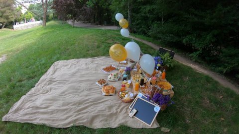 Porto, Portugal, June 27, 2021: Bachelor and bachelorette party Picnic at Porto City Party in Oporto, Portugal. Blanket with food prepared for summer picnic outdoor. 