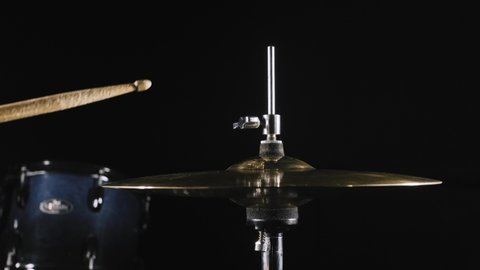 Studio cymbal hi-hat double stroke. drumkit sticks hit close and open hi-hat. drummer playing on drum kit on stage or in a dark studio with muffled lighting. Performance vocal and musical band.