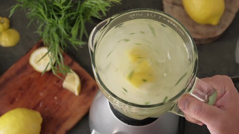 Making homemade lemonade with ice. Cold non-alcoholic summer drink. Cooling drink preparation concept. 4K video in real time
