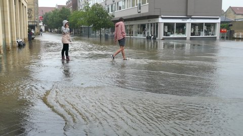 Netherlands - 15 july 2021, Valkenburg: Flooding after heavy rain in the province of South Limburg- people walking on flooded streets
