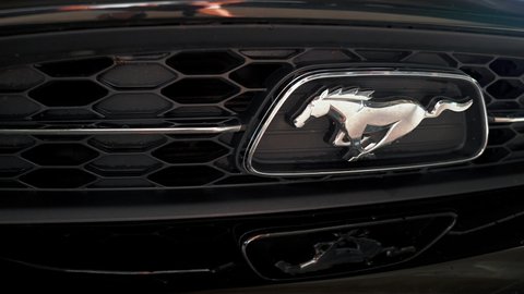 CALIFORNIA, USA JUNE 19, 2021. Black Ford Mustang model logo close up view. Horse symbol in a Ford Mustang.