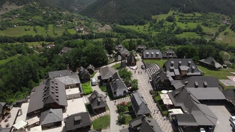 Mecavnik, Kustendorf, Mokra Gora, Serbia. Drone Aerial View of Hilltop Ethno Village in Green Mountain Landscape on Sunny Summer Day, Drone Shot