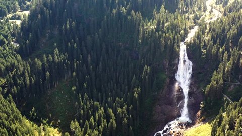 Top View at the Krimml Waterfall Cascades among a forest. Drone Flight Above the Flow