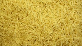 Uncooked small pasta noodles texture rotating