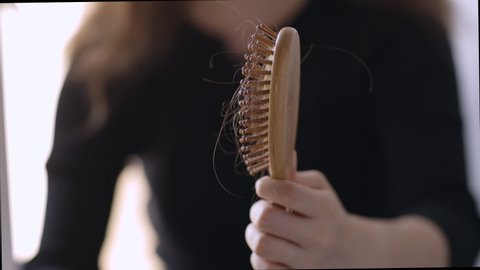 hairbrush with close-up hair, hair loss, stress and depression High quality FullHD footage