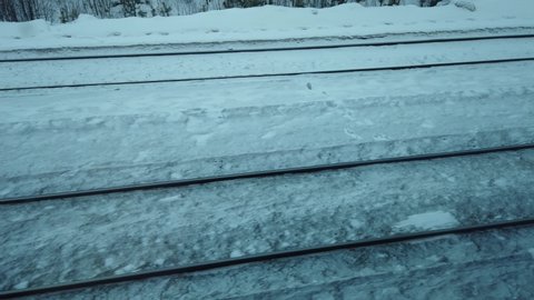 View on railroad track from the window of train. motion along rails on the railway. winter weather