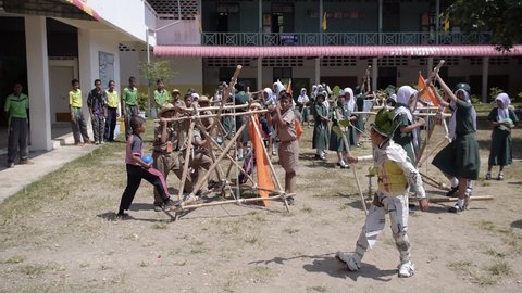 Yala, Thailand March 11, 2016  Thai Boy Scout activities happy boys and girls thorough water balloons from hand made wooden catapult, joy and fun, Muslim Students Ban Yala primary school, slow motion