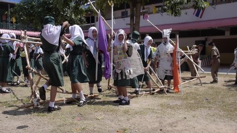 Yala, Thailand March 11, 2016  Thai Boy Scout activities happy boys and girls thorough water balloons from hand made wooden catapult, joy and fun, Muslim Students Ban Yala primary school, slow motion
