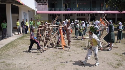 Yala, Thailand March 11, 2016 Thai Boy Scout activities happy boys and girls thorough water balloons from hand made wooden catapult, joy and fun, Muslim Students Ban Yala primary school