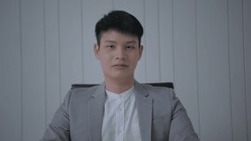 Business concept of 4k Resolution. Young Asian businessman giving an interview in the office.