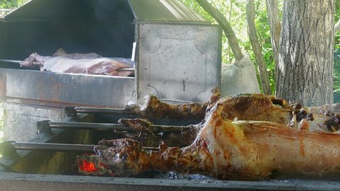 Traditional spit-roasted lamb, very tasty meat in a restaurant. Grilled lamb rotated and roasted evenly