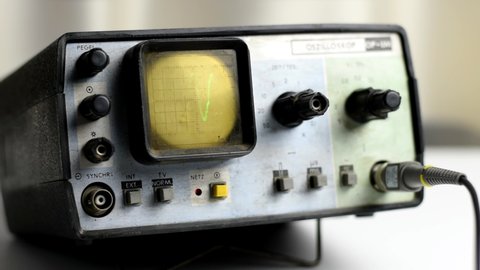 Old oscilloscope. Measuring a circuit with an oscilloscope. Signal transmission.
