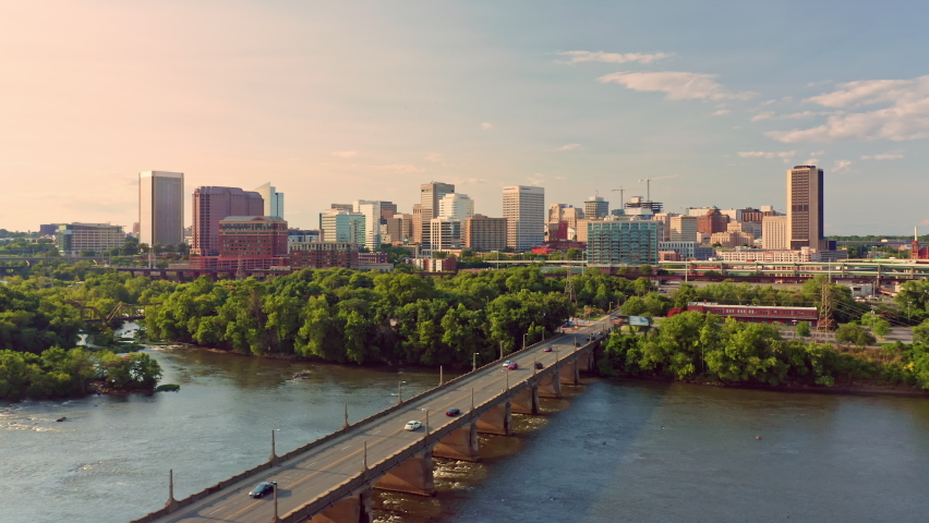 Aerial view of Richmond, Virginia, at sunset with slow camera lift up. Richmond is the capital city of the Commonwealth of Virginia. Manchester Bridge spans James River | Shutterstock HD Video #1076012810