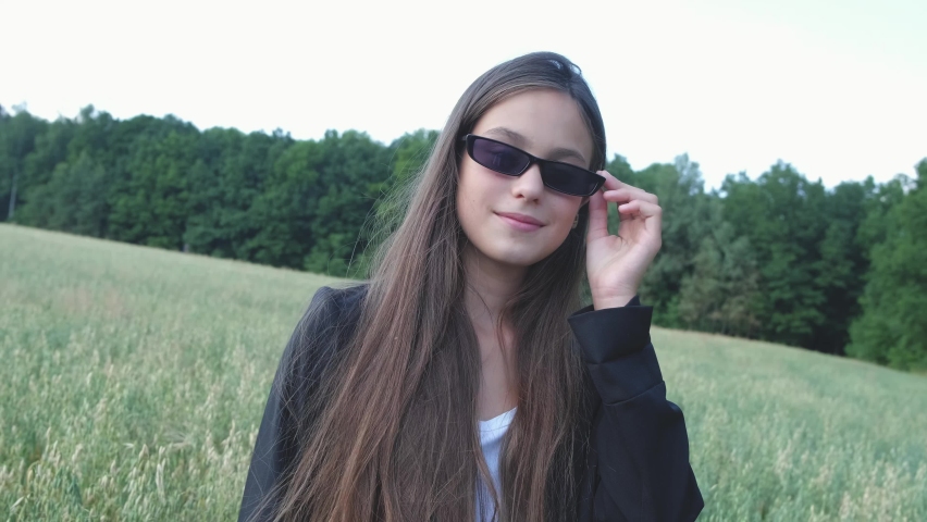 a young stylish model with glasses in nature.young teenage girl