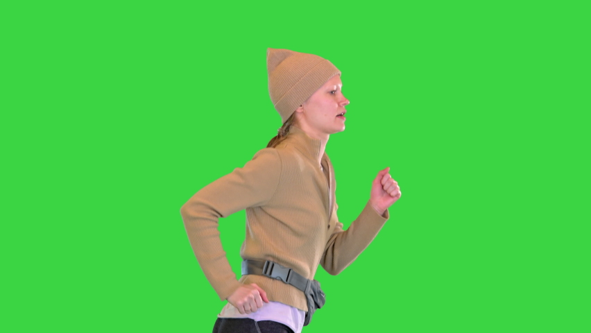 Female runner training jogging outdoors on a Green Screen, Chroma Key.