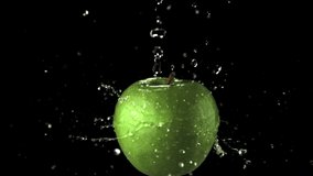 Super slow motion water droplets fall on the rotating apple. On a black background. Filmed on a high-speed camera at 1000 fps. - Powered by Shutterstock - Get 15% off with code: PIKWIZARD15