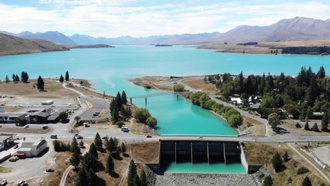 Beautiful aerial view of dam and bridge in Lake Tekapo. Colourful summer scenery of New Zealand