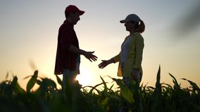 Agriculture. two farmers shake hands, conclude a business contract for a corn field. agriculture sale harvest concept. business handshake of farmers in sunlight a corn field. shake hands agriculture - Powered by Shutterstock - Get 15% off with code: PIKWIZARD15