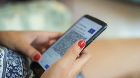Woman check her covid19 vaccination green pass certificate on a smartphone,qr code technology - Powered by Shutterstock - Get 15% off with code: PIKWIZARD15
