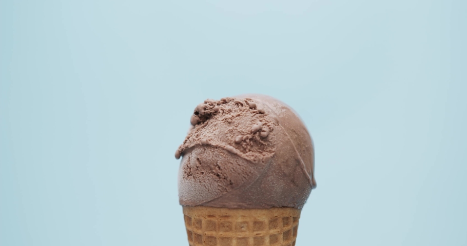 Hand scoop ice cream strawberry on top chocolate ice cream waffle cone isolated on a blue background, Front view Food concept. Royalty-Free Stock Footage #1076045219