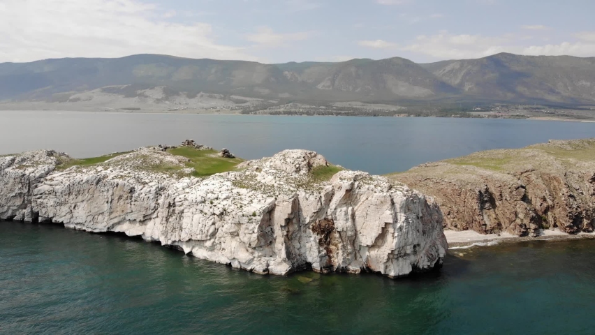 Beautiful shore of Baikal lake with clear blue water. Aerial drone view. Baikal lake, Siberia, Russia. Beautiful spring landscape.