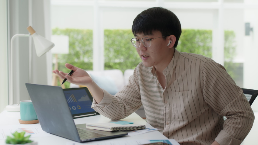 Asia people glasses chinese male busy talk discuss on desk at home in employee digital reskill upskill class, social distance college learner, staff worker job self training, study MBA on VoIP webcam. | Shutterstock HD Video #1076048999