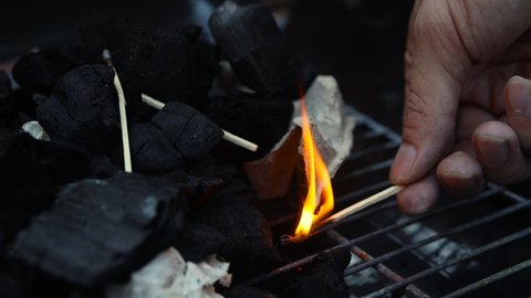 kindling coals in the grill. open fire. summer picnic.
Outdoor recreation.