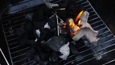 kindling coals in the grill. open fire. summer picnic.
Outdoor recreation.