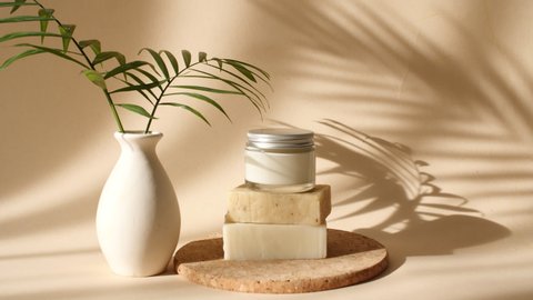 Cream in a Glass Jar on Beige Podiums From Bars of Soap in Sun Light. Shadows Palm Leaves. Minimal Abstract Cosmetic Background for Product Presentation. Product Presentation.