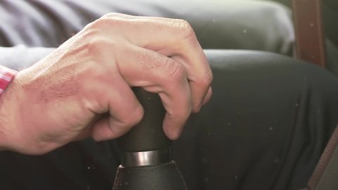 Businessman Driving to Work, Hand Shifting the Gear Stick. Close Up. Zoom Out. 4K Resolution.