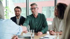 Businessman handshaking partner at group meeting making business agreement contract deal, concluding trust partnership contract after negotiations with lawyers international team at conference table. - Powered by Shutterstock - Get 15% off with code: PIKWIZARD15