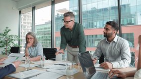 Executive team business people listening to ceo negotiating discussing project results at board meeting. Multicultural professional company leaders working sitting at boardroom table in office. - Powered by Shutterstock - Get 15% off with code: PIKWIZARD15