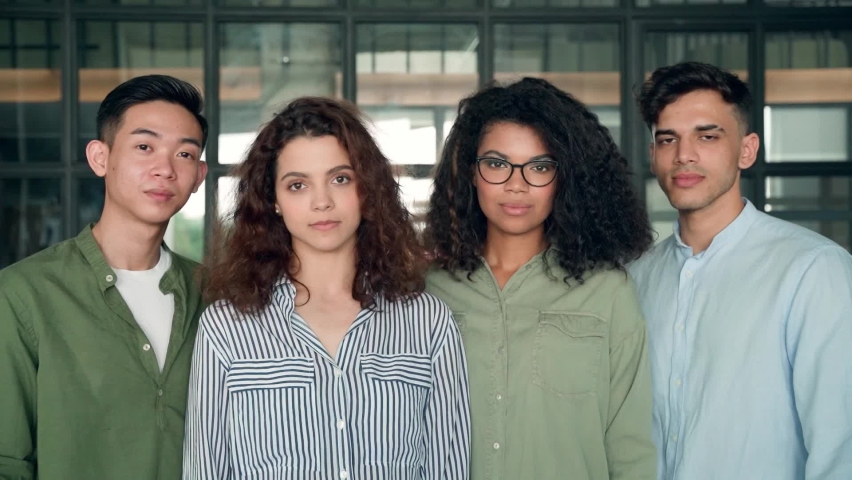 Four multiracial happy smiling diverse colleagues international business startup creative team students standing looking at camera posing in modern office. Ethnicity, diversity, cooperation concept. Royalty-Free Stock Footage #1076060045