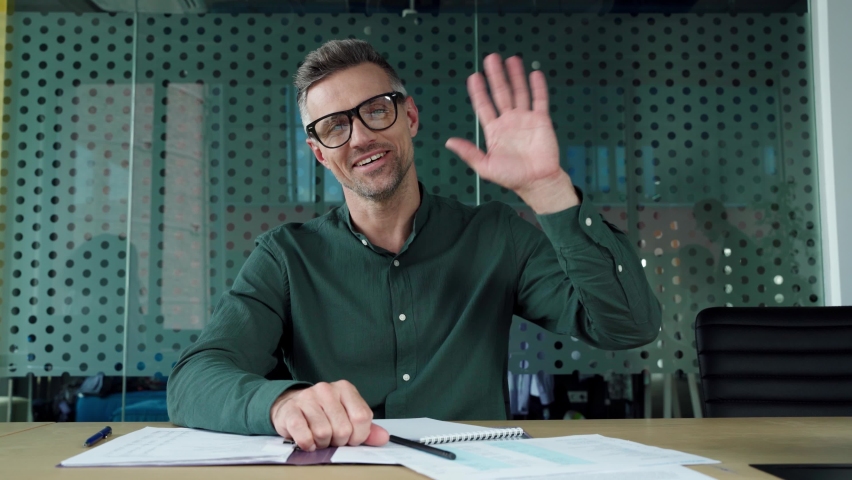 Mature business man ceo executive talking to web camera on video conference call training, having virtual meeting remote working showing financial report, making presentation in office. Webcam view - Powered by Shutterstock - Get 15% off with code: PIKWIZARD15