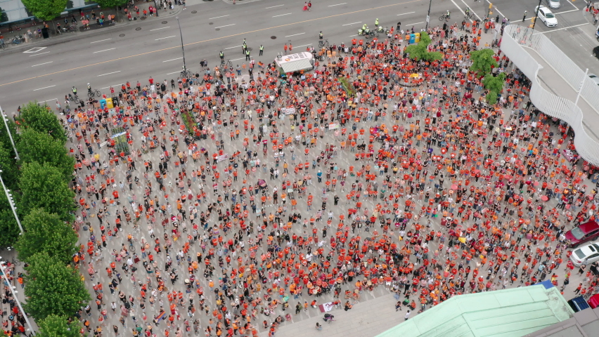 Aerial Overhead View of the Cancel Canada Day Protest at the Vancouver Art Gallery. Cinematic drone shot of Indigenous people in Orange Shirts during the Residential Schools mass graves news Royalty-Free Stock Footage #1076064095