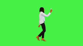 Happy black businesswoman has video call online on mobile smart phone walk cheerful talk and smile on a Green Screen, Chroma Key.