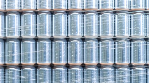 Aluminum cans stacked on pallet rack in beer brewery warehouse. New 500 ml aluminum containers for cold beverages and canned drinks filmed in close up video clip