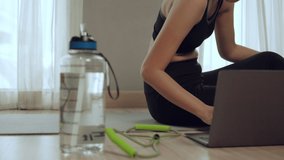 Lockdown activities, woman training online at home on laptop computer via home internet.