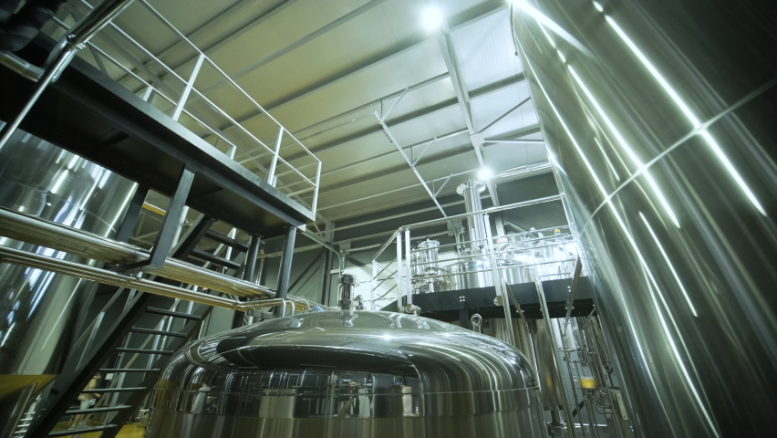 Modern craft brewery. Craft beer production. Modern equipment in brewery, metal tanks, alcoholic drink production