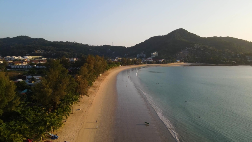 4K Aerial Side View, Kamala Beach during Sunset. Beach, sea and sand. Drone view of a beautiful white tropical sand beach on a summer day in Thailand. Top view empty and clean beach. Phuket, Thailand | Shutterstock HD Video #1076080121