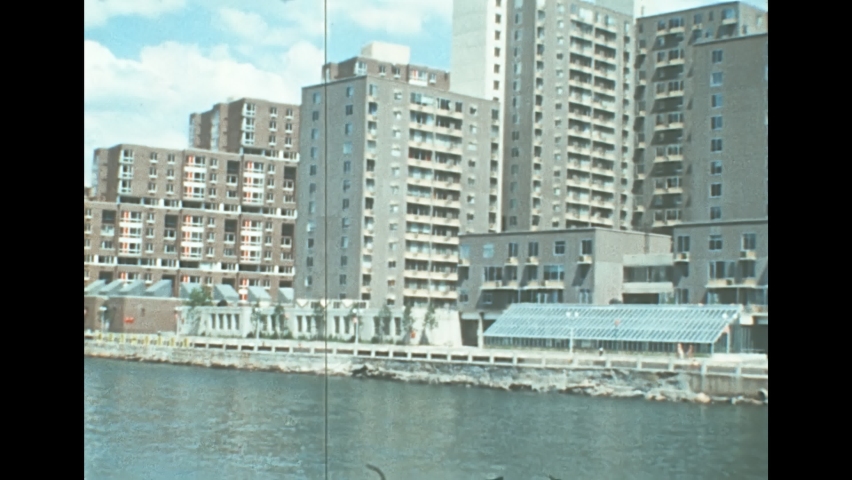 Archival of Long Island skyline by sea view from East river sightseeing cruise in New York. Old house buildings of the old New York city. United States of America in 1976. Vintage USA from 70s.