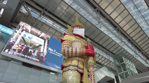 Bangkok, Thailand on July 17,2021 the 4k motion footage capture from the rear side of giant statue in the Suvarnabhumi airport.It had been  put the face mask on its face, exhibit of Covid-19 pandemic.