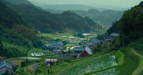 Terraced rice paddies in the Kamura area of Asuka Village, Nara Prefecture, a village at the foot of a mountain overlooked by a mountain pass.