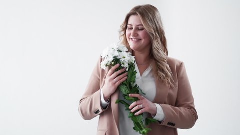 Online dating. Woman day surprise. Body positive. Holiday gift delivery. Happy overweight obese lady receiving white flower bouquet isolated on light.