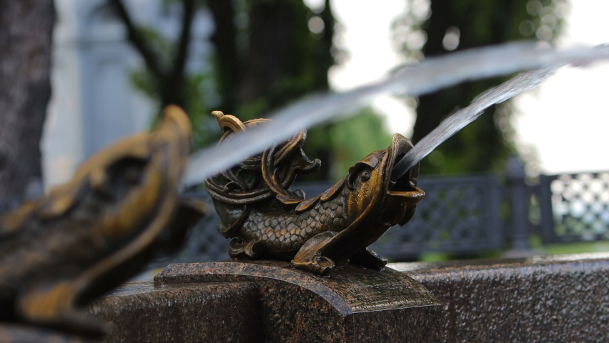 Metal sculpture. Fish shape fountain. Fresh water stream. City sight.